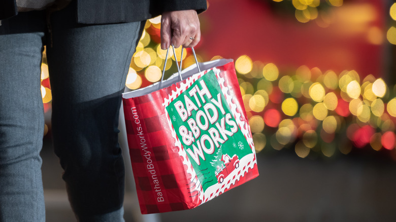 Shopper holding Bath & Body Works holiday bag