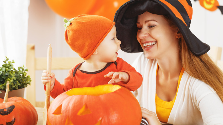Happy baby in pumpkin Halloween costume