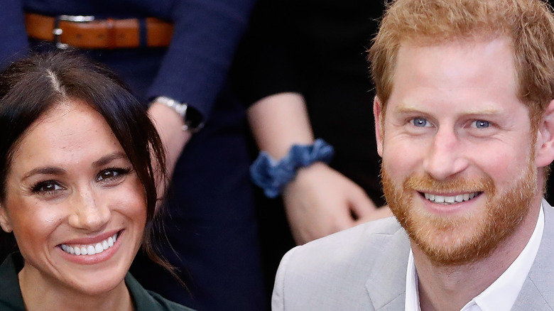 Meghan and Harry smiling at an event