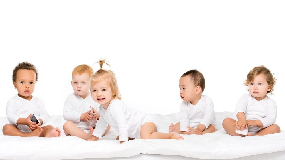 Group of babies of various genders and ethnicities