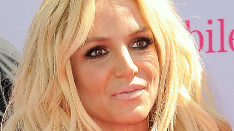 Britney Spears wears a black dress on the red carpet.