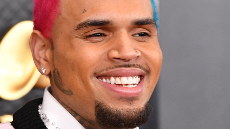 Chris Brown with red and blue hair and facial hair