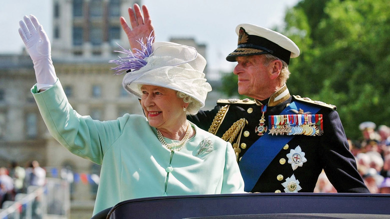 Queen Elizabeth and Prince Philip waving 