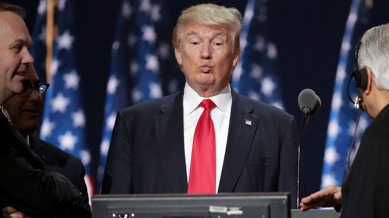 Donald Trump making a face in front of a screen