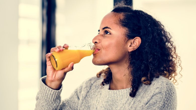 A woman drinking juice