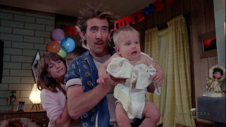 Nicolas Cage holding a baby in Raising Arizona