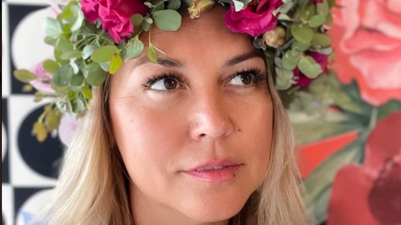 Jenny Nashama Barker posing with floral headpiece