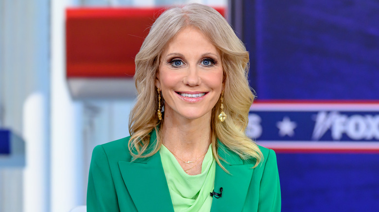 Kellyanne Conway smiling in green suit