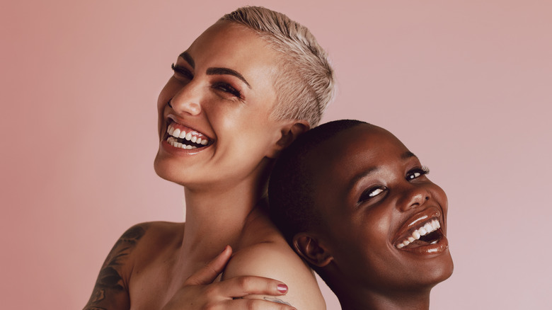 Two women with buzz cuts laughing