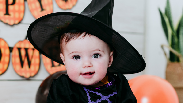 Baby in witch Halloween costume