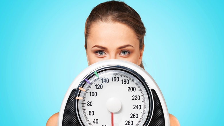 Lose weight woman with scale
