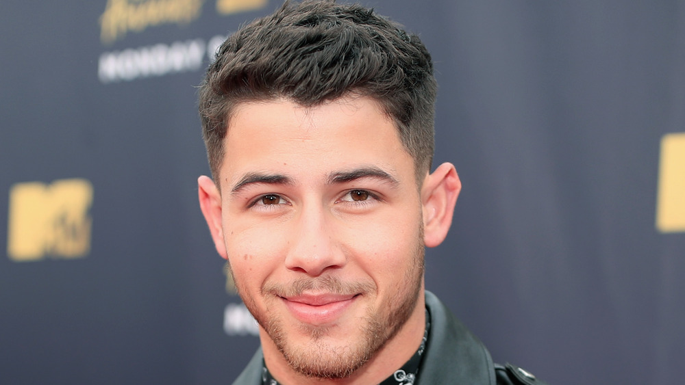 Nick Jonas poses on the red carpet