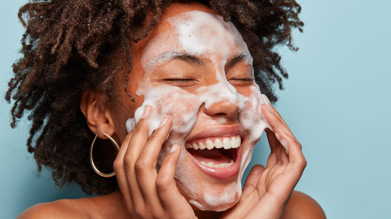 Woman using foaming cleanser