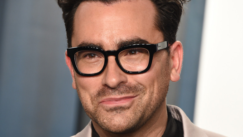Dan Levy smiles for the camera.
