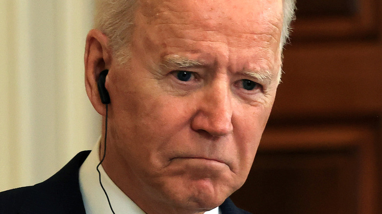 President Joe Biden listening to headphones