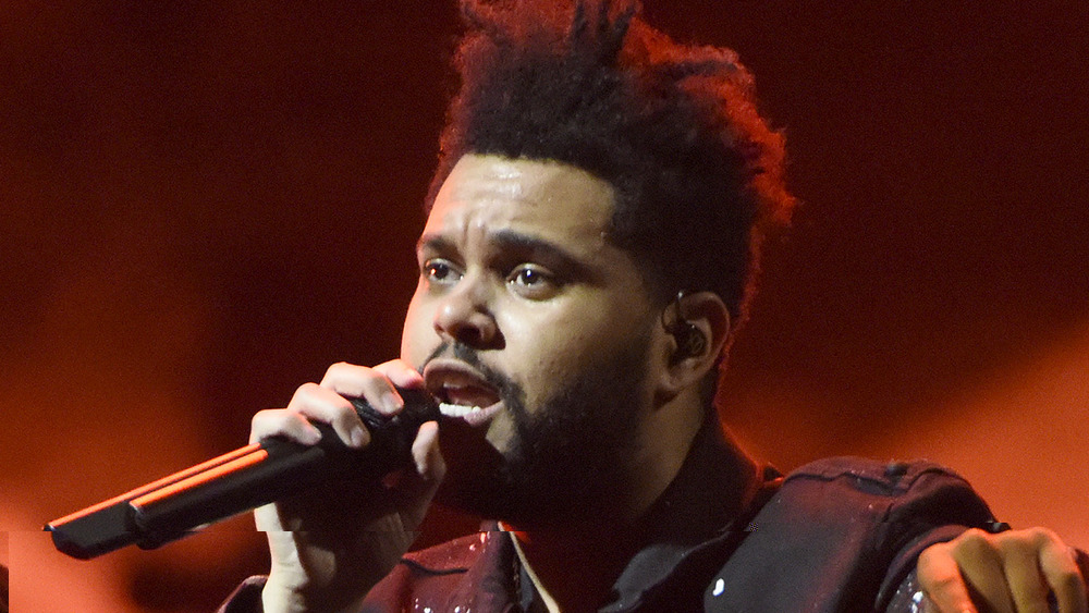 The Weeknd sings in concert