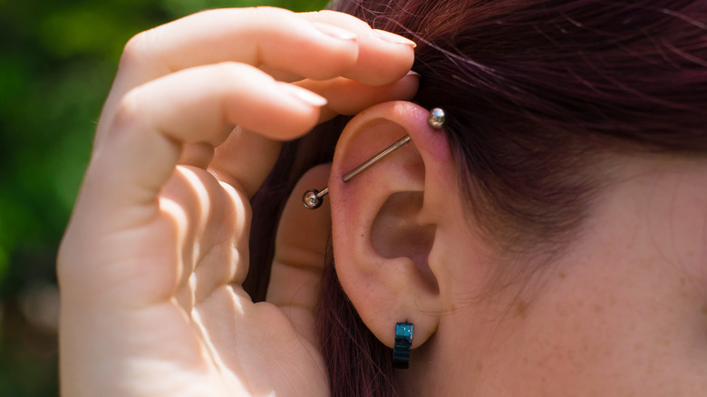 Woman with a cartilage and earlobe piercing