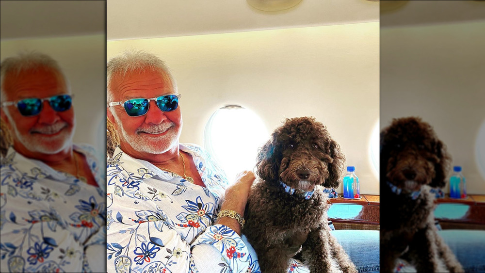Below Deck's Captain Lee Rosbach smiling while petting his dog