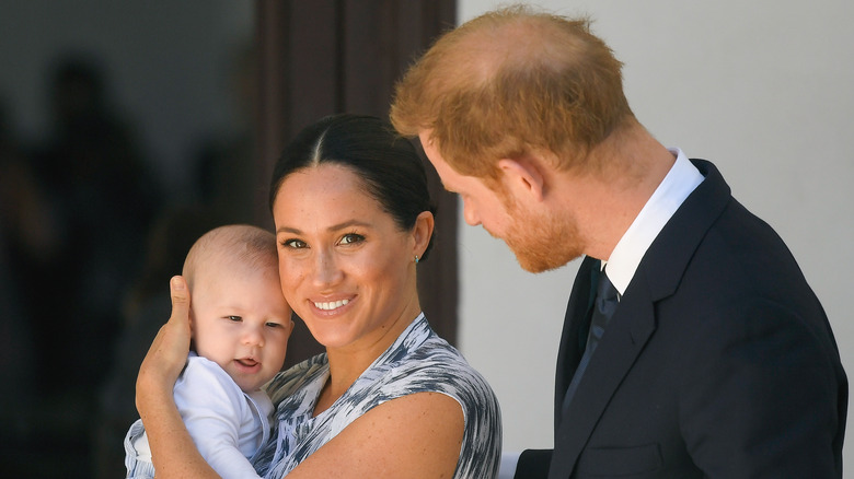 Meghan Markle holding Prince Archie with Prince Harry