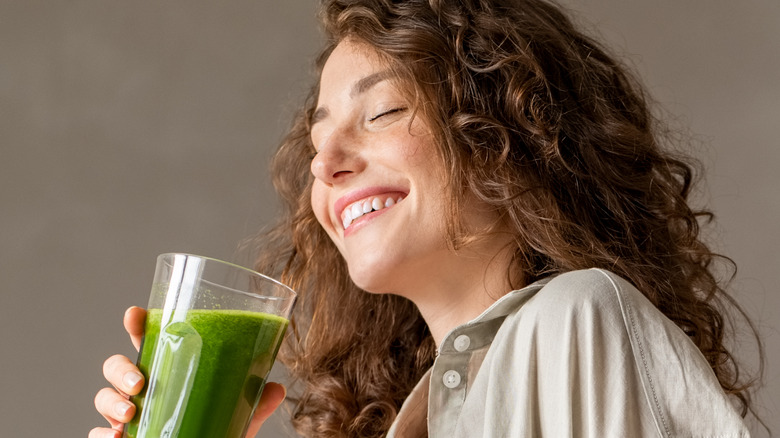 Woman drinking a green smoothie