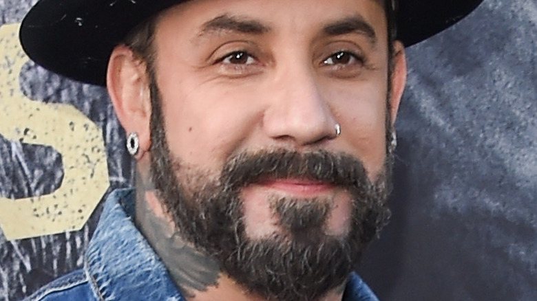 Aj McLean with slight smile and facial hair