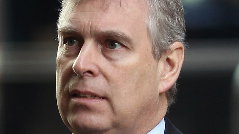 Prince Andrew with a dark suit and patterned tie
