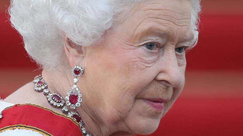 Queen Elizabeth looks over her shoulder