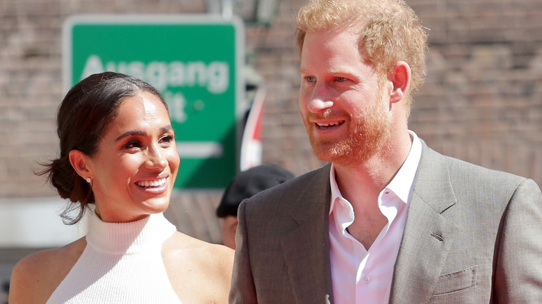 Harry and Meghan smiling at an event