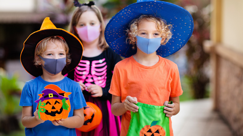 Three children going trick-or-treating