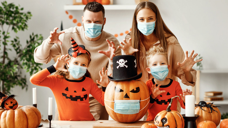 Family Halloween party with jack-o-lantern