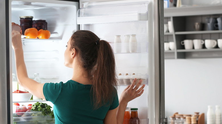 Woman taking food out of the refrigerator
