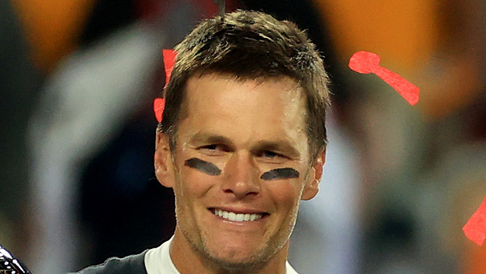 Tom Brady smiling after Super Bowl win with confetti eye black