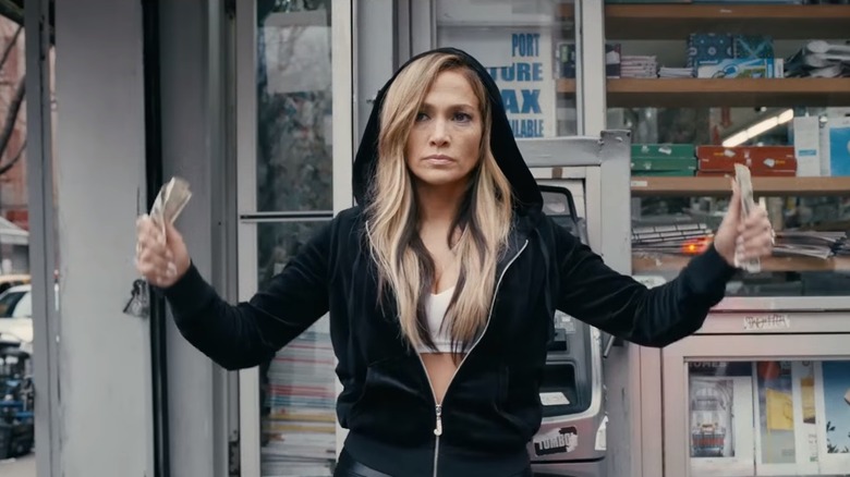 J-Lo with fists full of cash in Hustlers