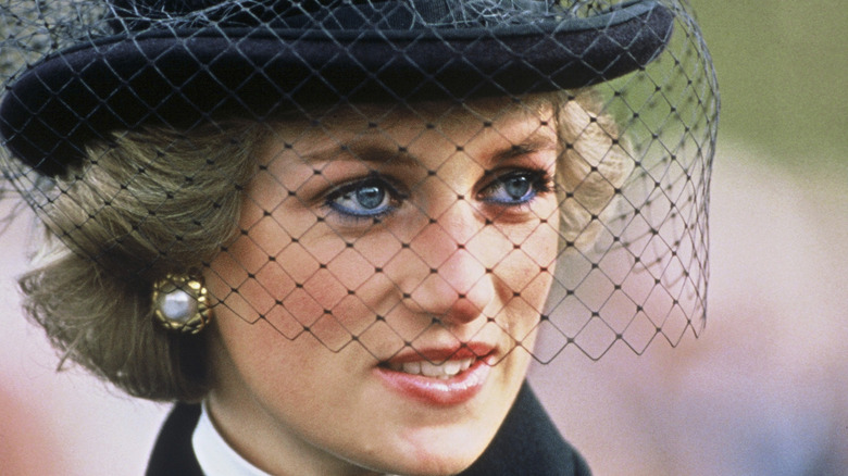 Princess Diana wearing black hat