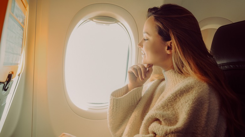woman on airplane window seat