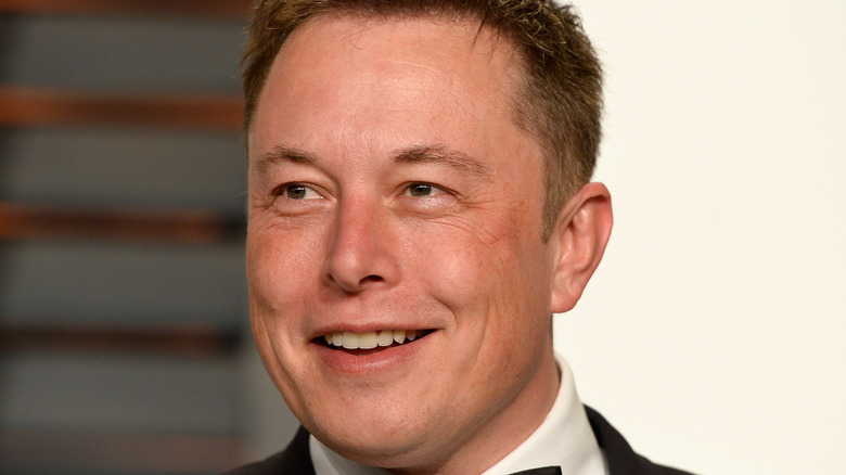 Elon Musk smiling at formal event 