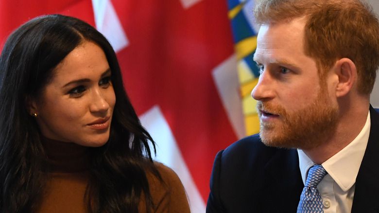 Prince Harry, Duke of Sussex and Meghan, Duchess of Sussex gesture during their visit to Canada House