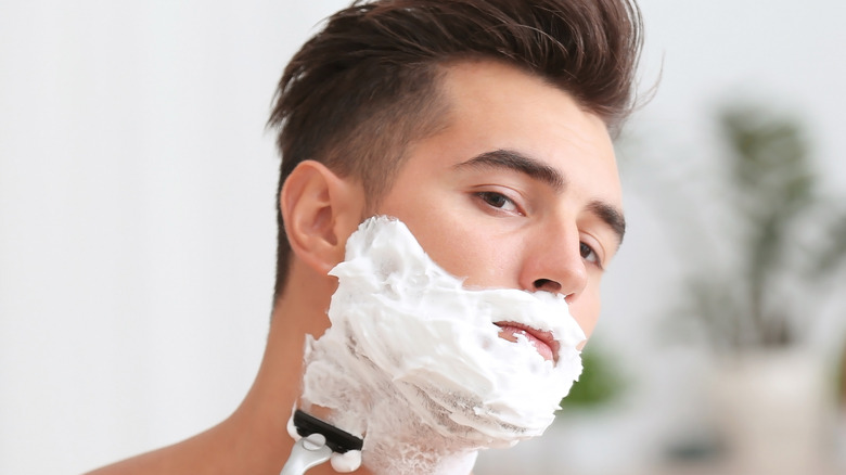 A man shaving his face 