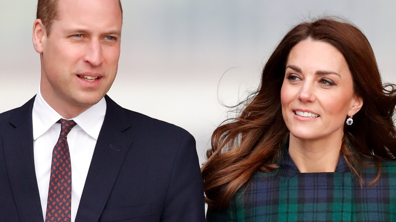 Prince William and Kate Middleton hold hands.