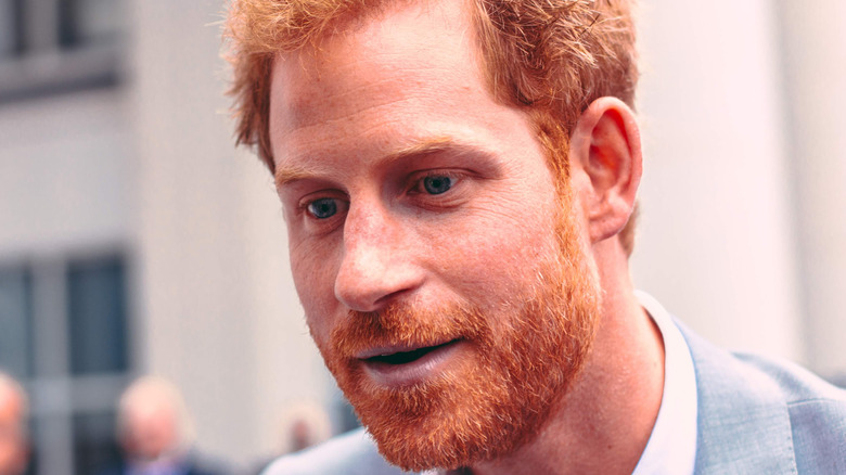 Prince Harry wears a gray suit. 