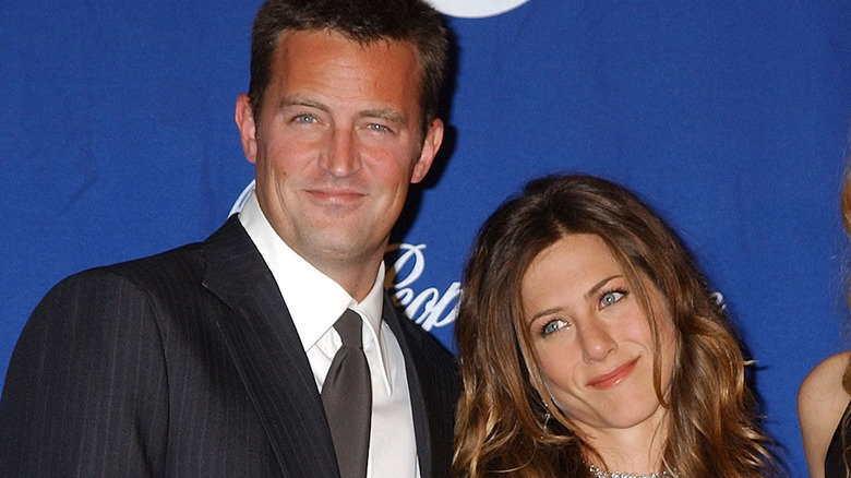Matthew Perry and Jennifer Aniston smiling at a red carpet event