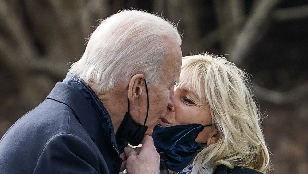 President Joe and Jill Biden sharing a kiss outside 