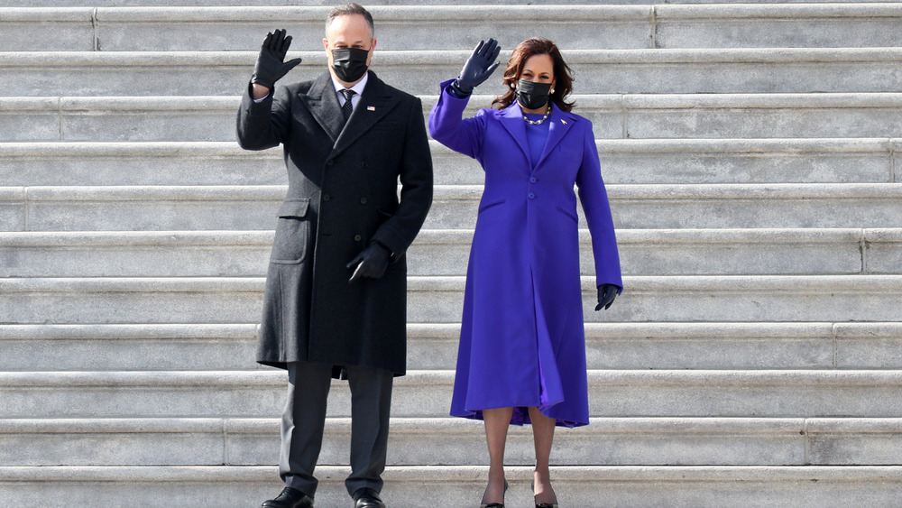 Kamala Harris and Doug Emhoff waving in masks