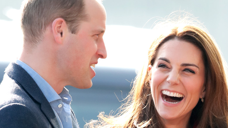 Kate Middleton laughing while in conversation with Prince William