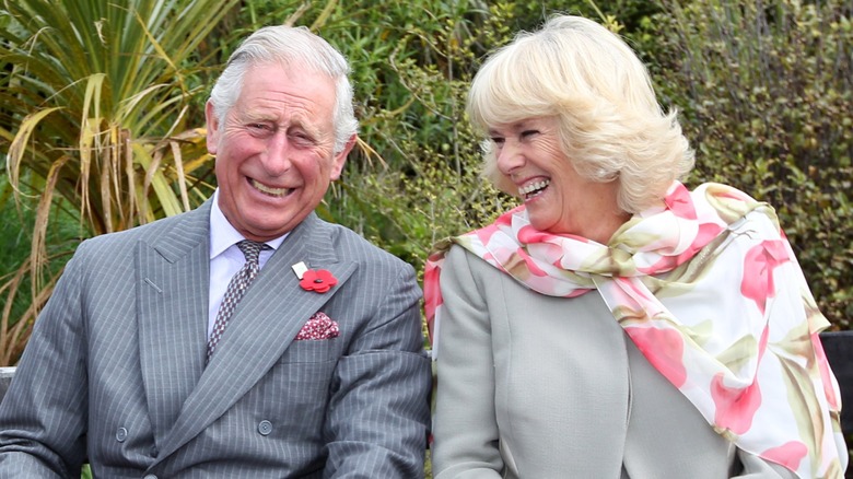 King Charles III Queen Camilla smiling, laughing