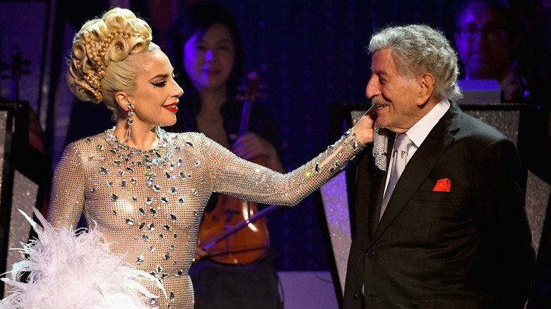 Lady Gaga affectionately touching Tony Bennett's shoulder