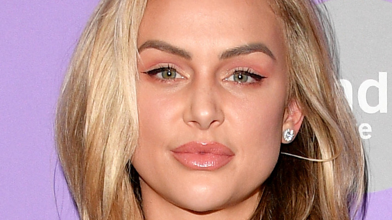 Lala Kent shows off her plump lips and wears diamond earrings.