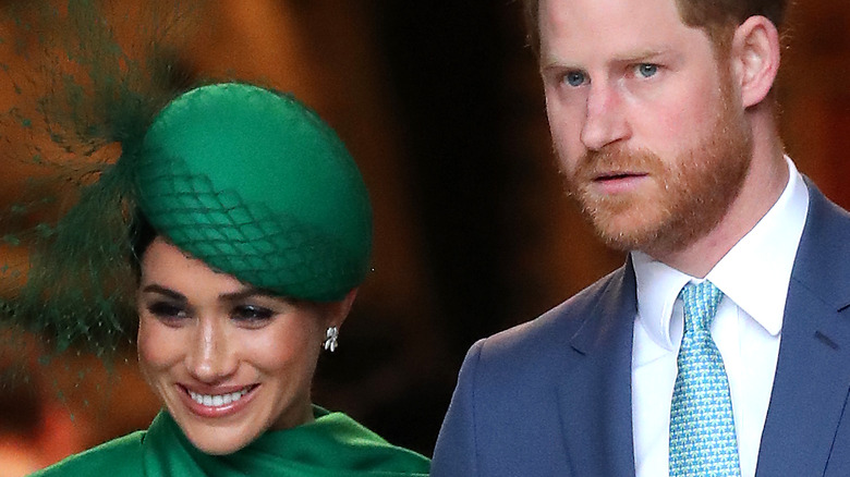 Meghan Markle smiling on Prince Harry's arm
