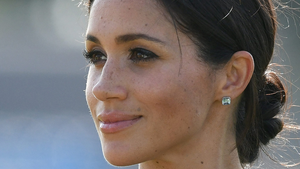 Meghan Markle looks away from camera