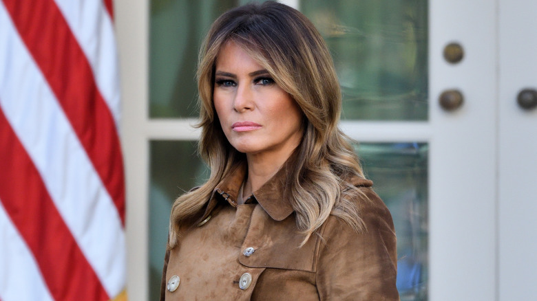 Melania Trump brown coat looking serious